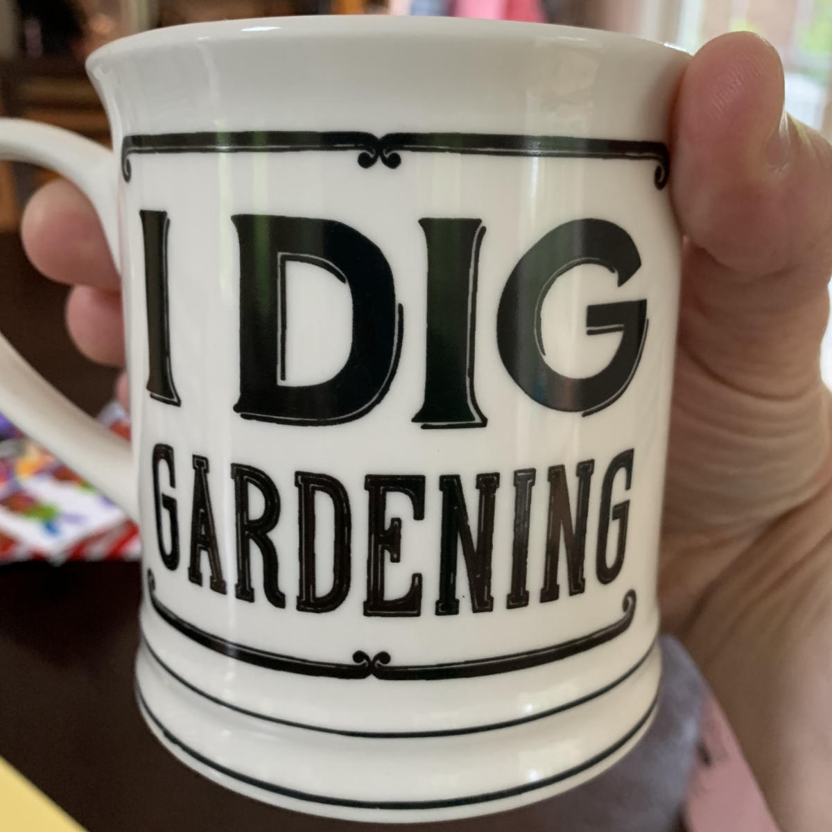 A coffee mug that says "I Dig Gardening"