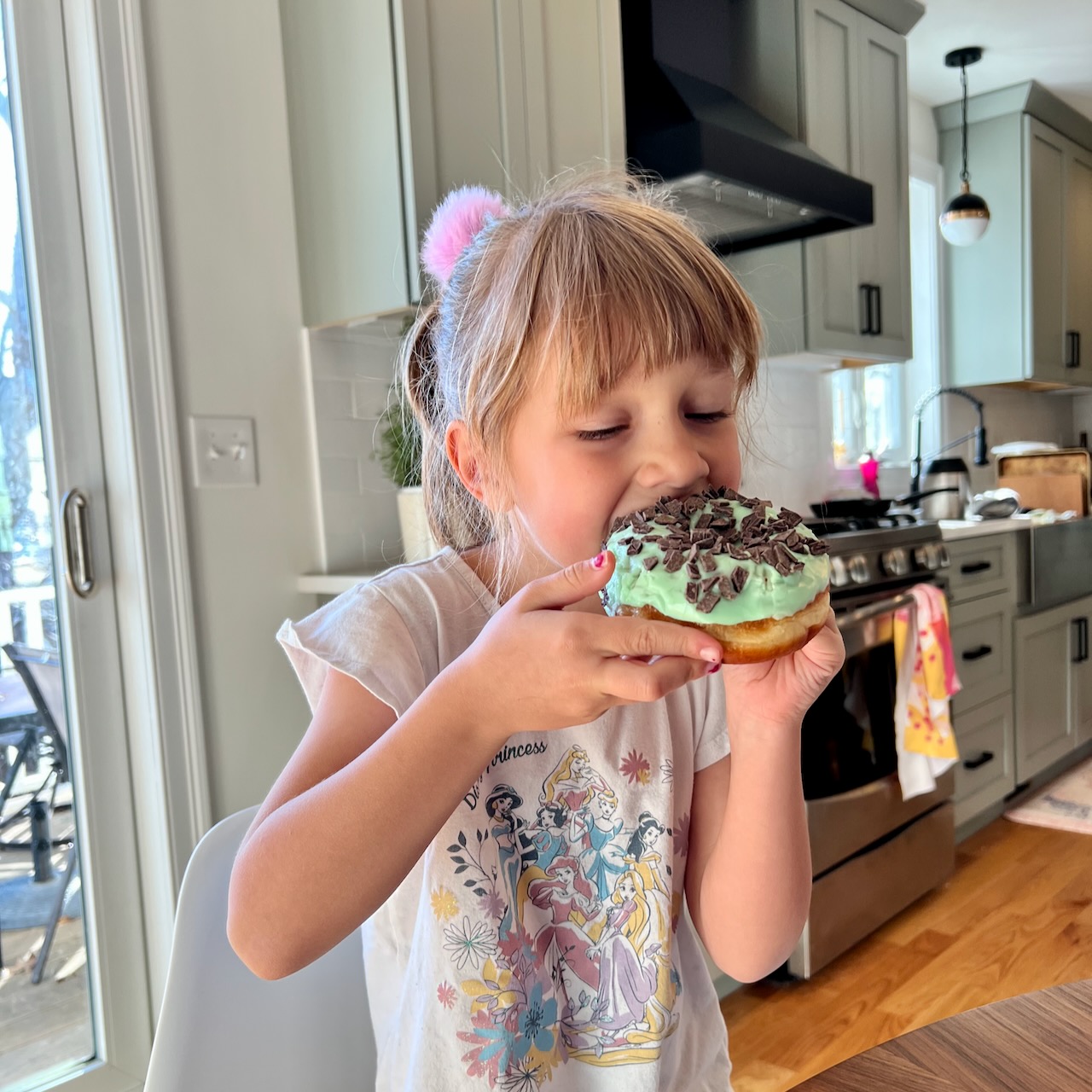 Lorelei eating a chocolate mint donut