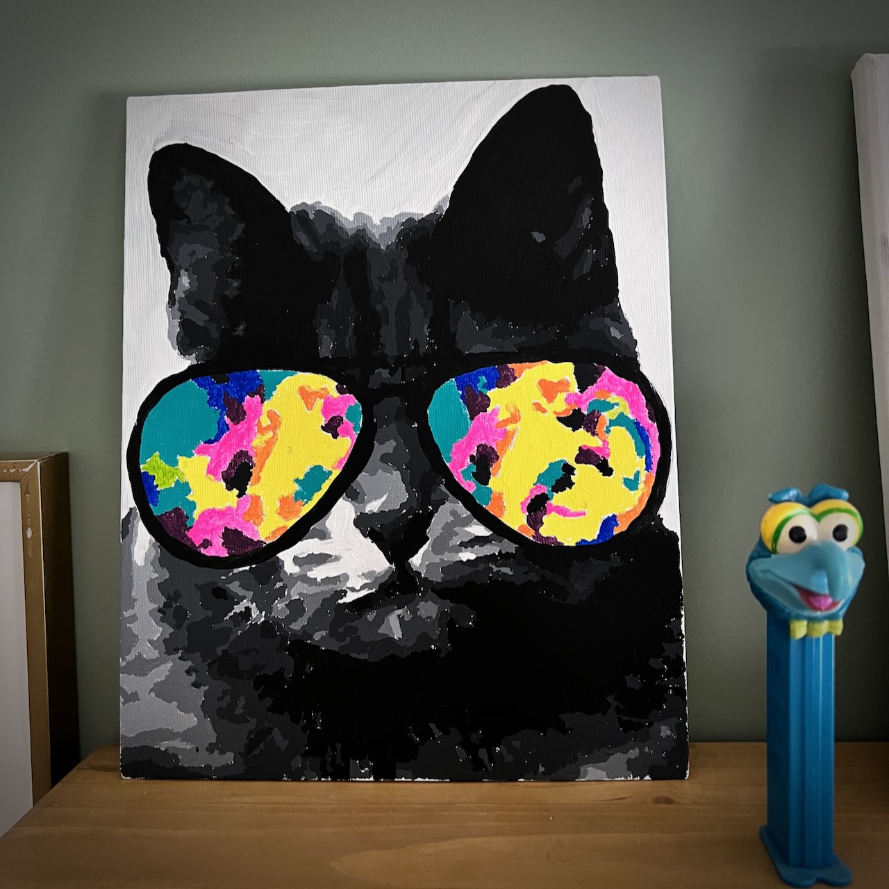 My finished paint by numbers picture of a cat with cool sunglasses.